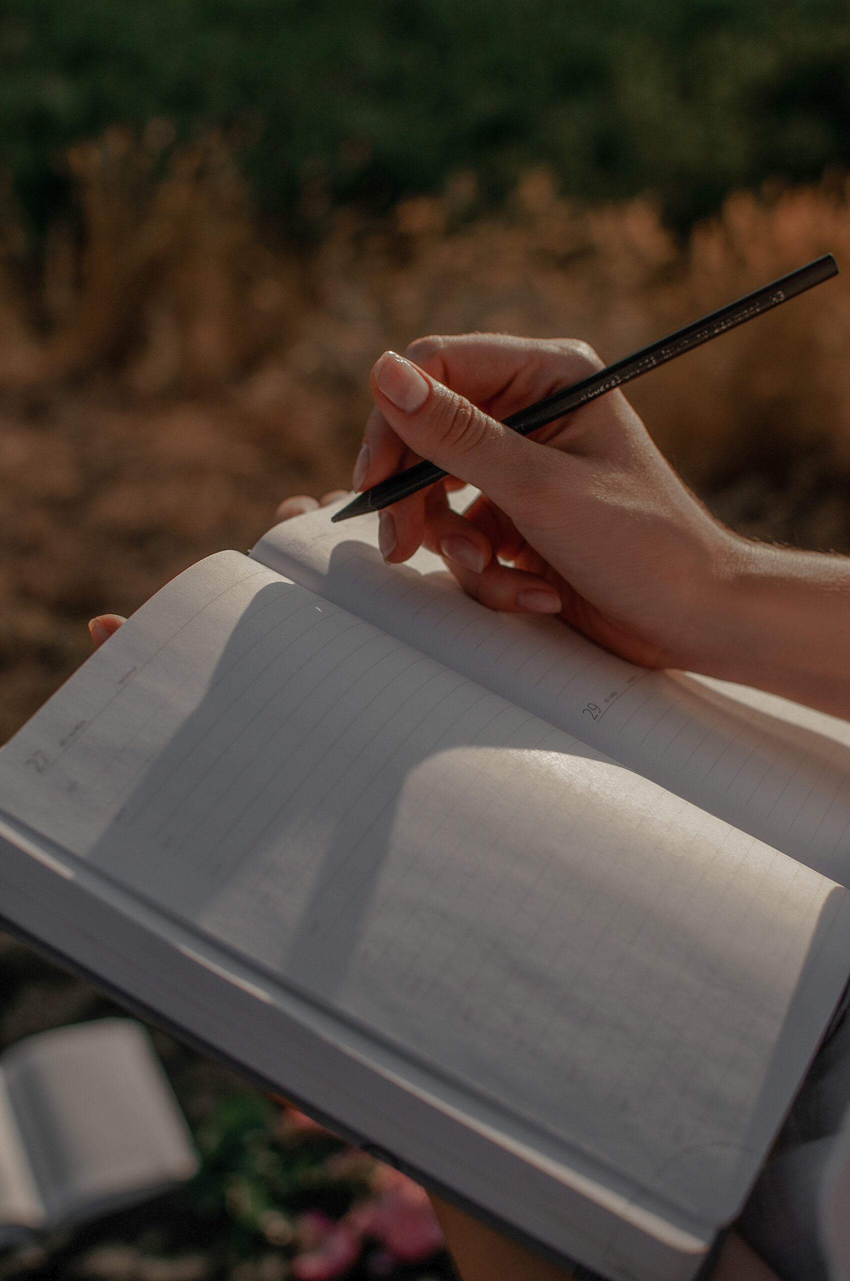 person writing in a book close up
